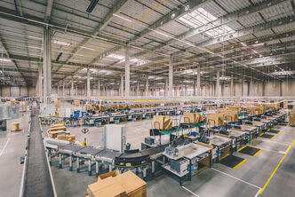A warehouse conveyor line with packing stations