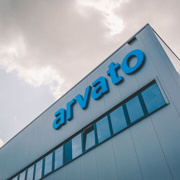 a corner of an arvato warehouse with an arvato logo in blue
