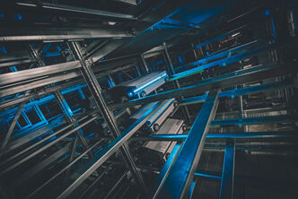 Warehouse shuttle system, dark with blue light