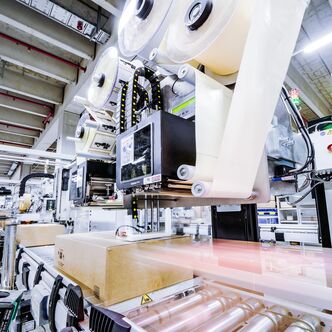 a conveyor system with carton sealer and warehouse labeling machine