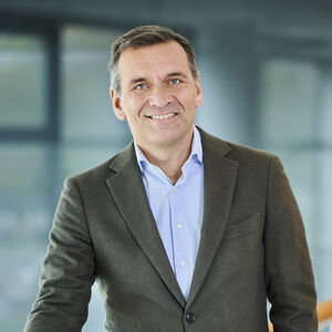 Douglas CEO sander van der laan douglas standing at a railing