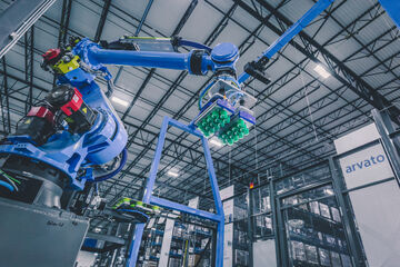 Depalletizing robot operating in front of warehouse racks to automate material handling processes