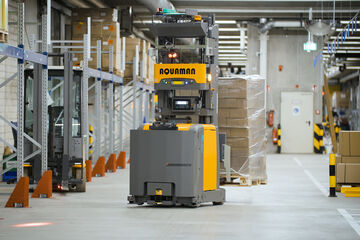 Automated guided vehicle transporting goods in an Arvato warehouse for efficient intralogistics