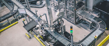 An automated warehouse labeling machine and conveyor system with various stations, sensors and screens